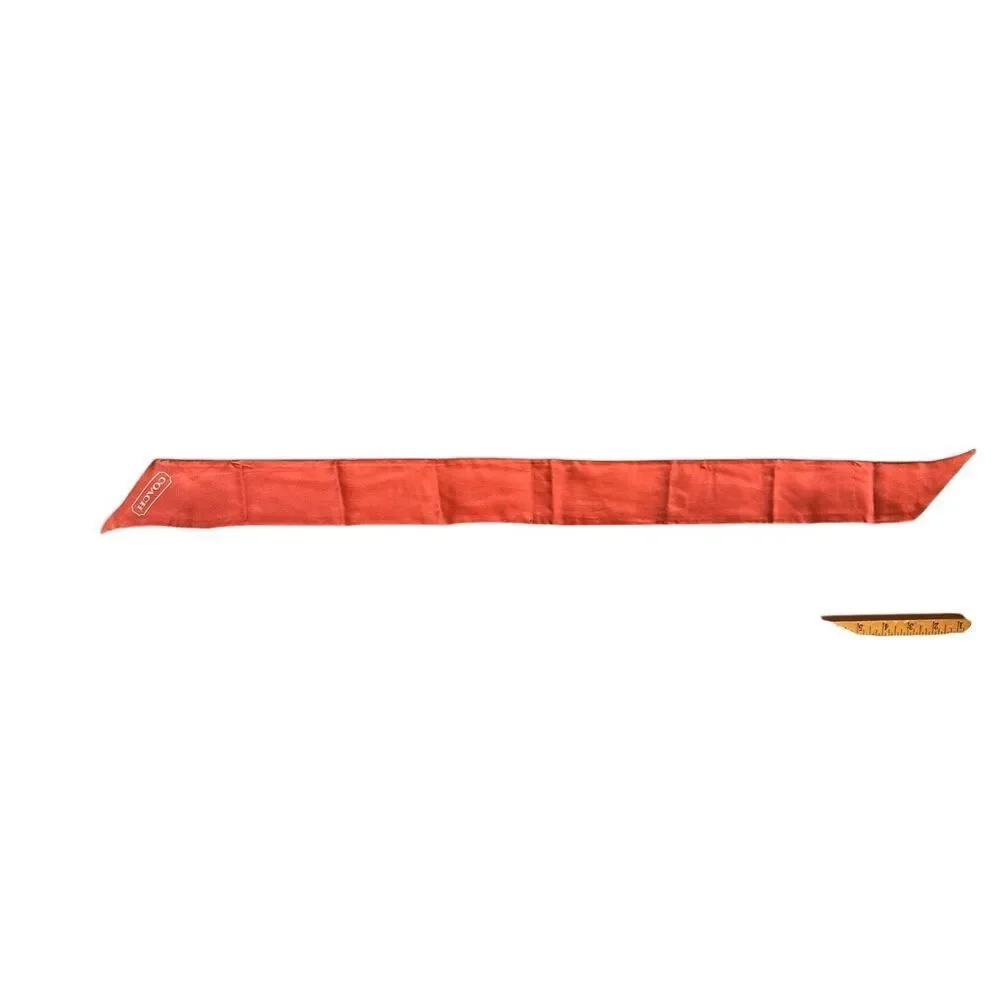 COACH silk twilly scarf orange poppy and tan signature Cs background